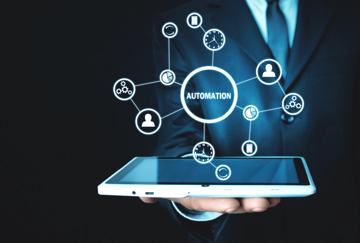 Businessman holding a tablet with automation icons and technology network connections, representing business process automation and digital transformation.